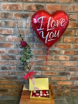 Single red rose in vase with a box of chocolates and Balloon